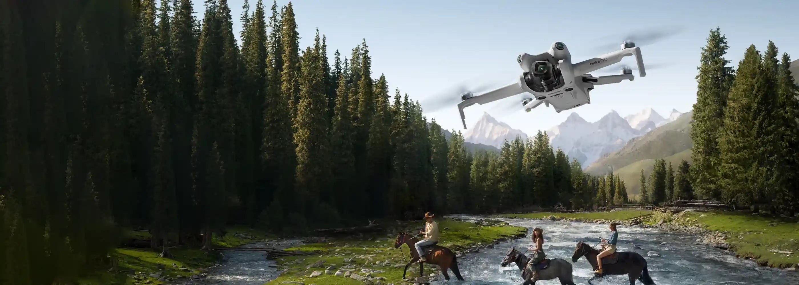 Drones flying over a scenic landscape with mountains and trees. Sold by an Authorized DJI Retailer.
