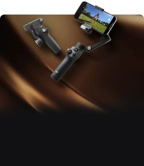 Handheld DJI smartphone stabilizer on a brown surface with a phone attached to it. Sold by a DJI authorized retailer.